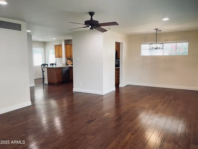 a view of a livingroom with a furniture wooden floor and a ceiling fan