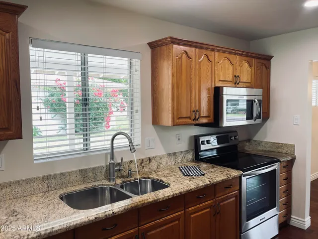 a kitchen with granite countertop a sink and a window