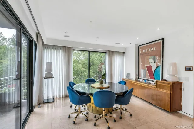 a living room with furniture and a floor to ceiling window