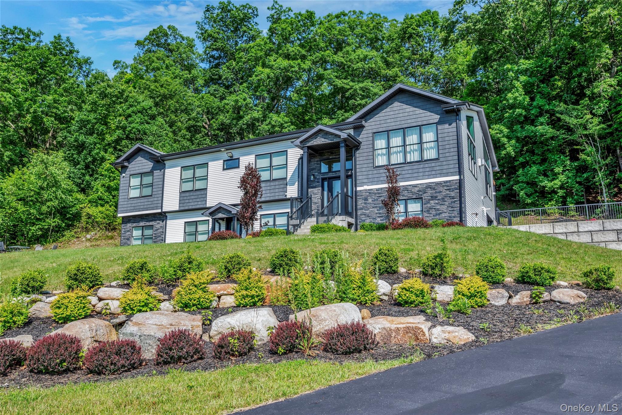 a front view of a house with a garden