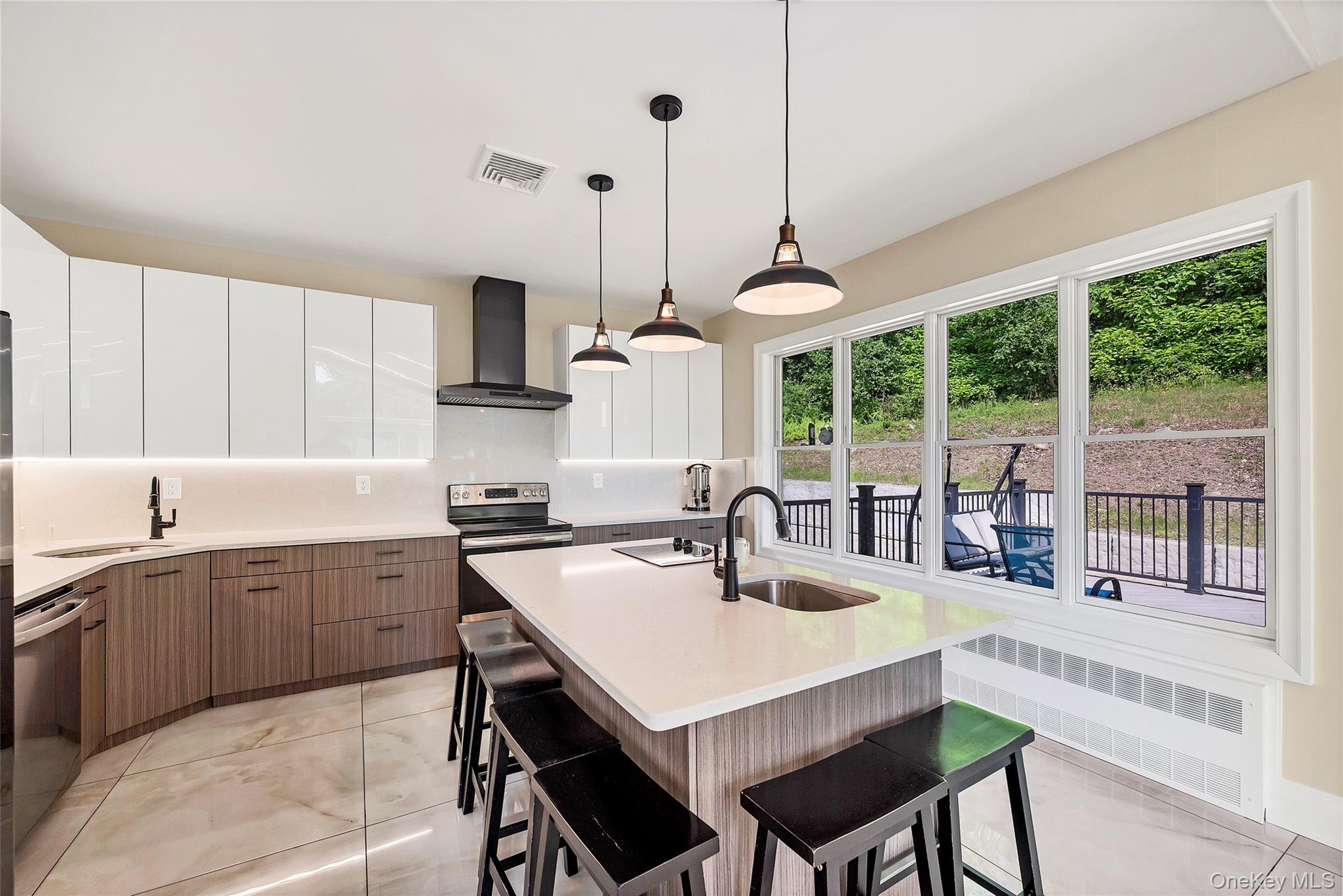 31 Walnut Ridge Lane Bloomingburg, NY 12721 - Photo 12 of 50 a kitchen with a stove a sink a dining table and chairs