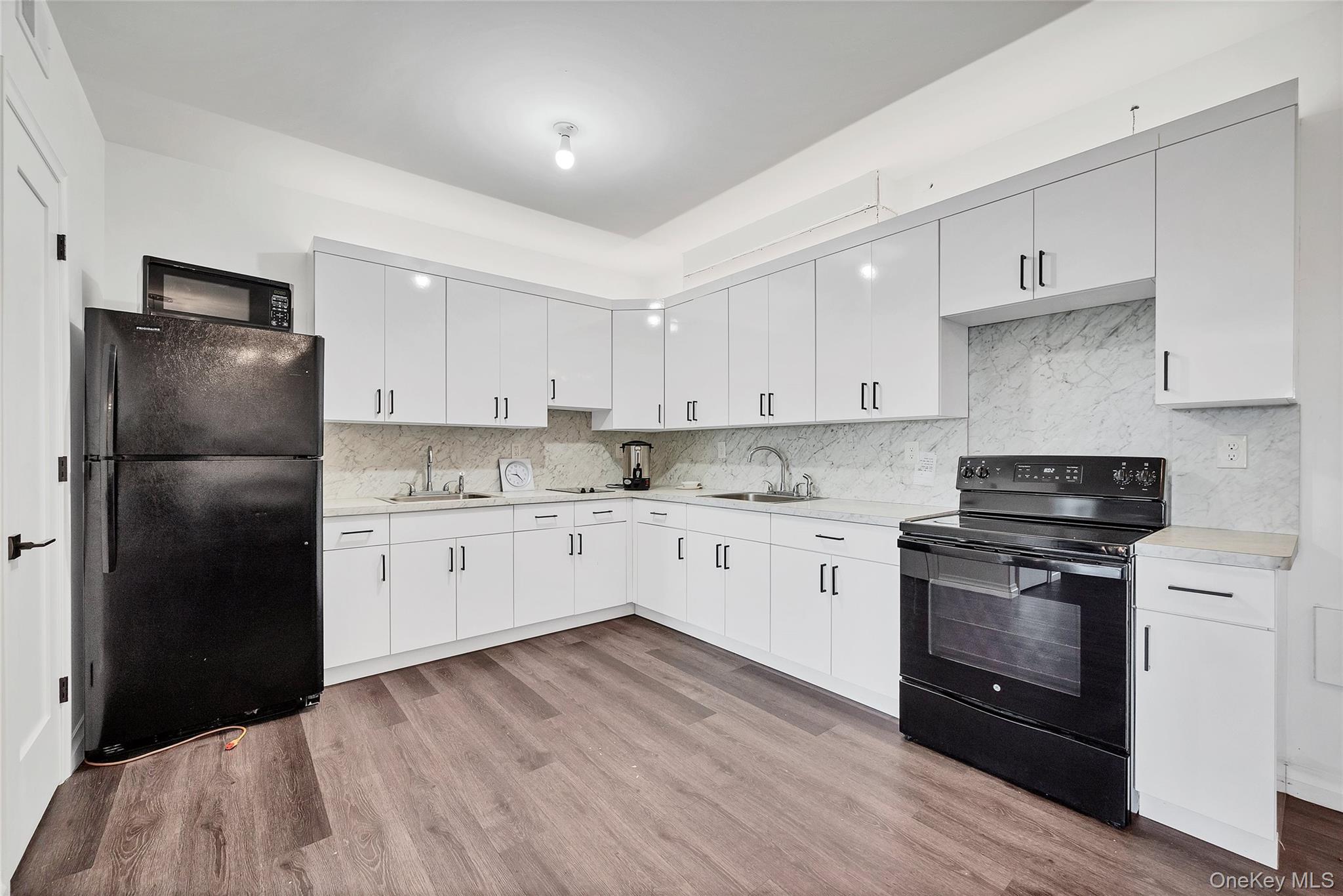31 Walnut Ridge Lane Bloomingburg, NY 12721 - Photo 34 of 50 a kitchen with a refrigerator stove and white cabinets