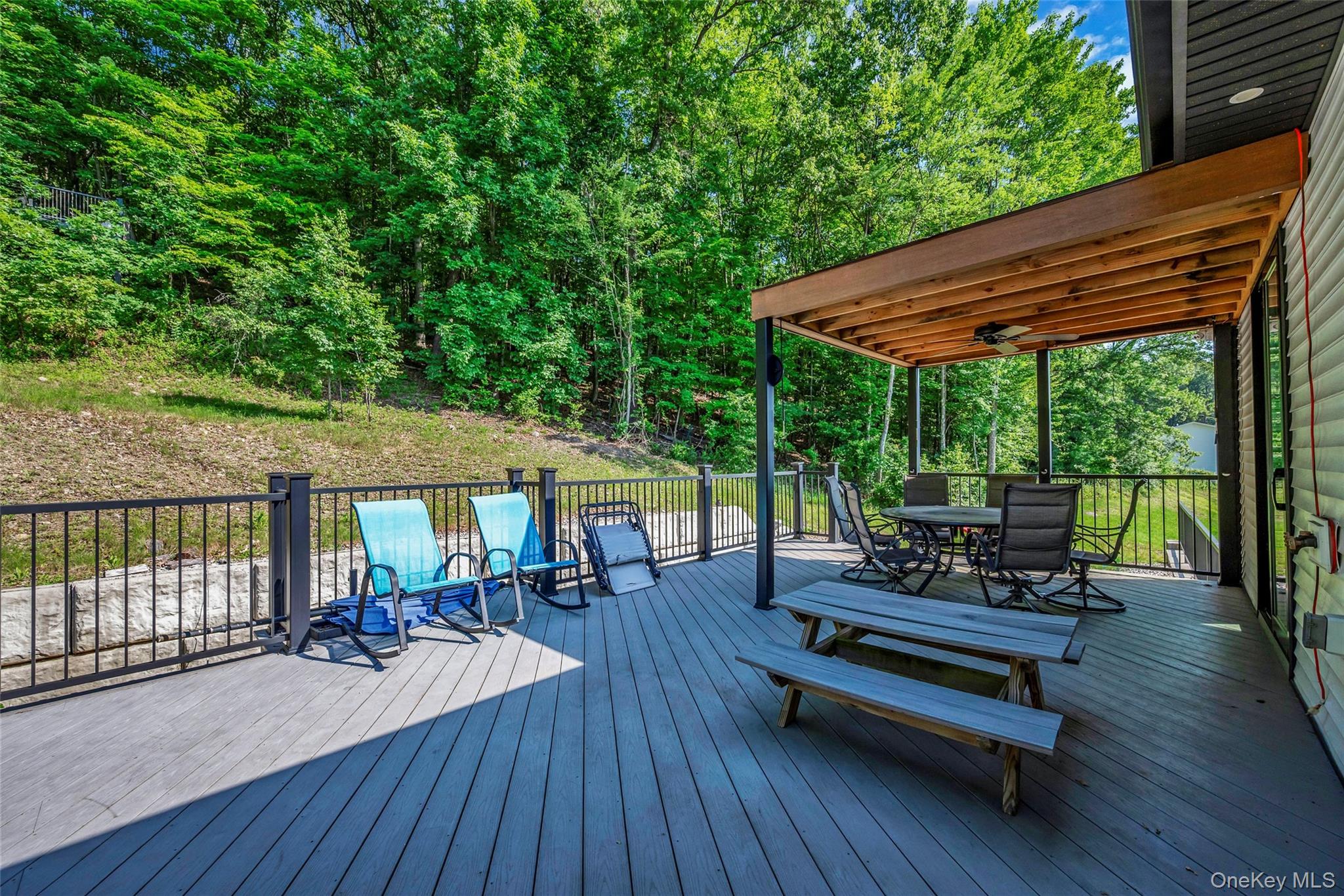 31 Walnut Ridge Lane Bloomingburg, NY 12721 - Photo 46 of 50 a view of a patio with wooden floor table and chairs