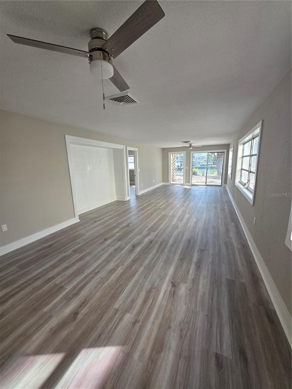 11750 Capri Circle South Treasure Island, FL 33706 - Photo 3 of 9 a view of an empty room with wooden floor and a window