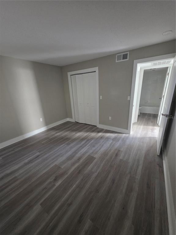 11750 Capri Circle South Treasure Island, FL 33706 - Photo 5 of 9 a view of an empty room with wooden floor and a window