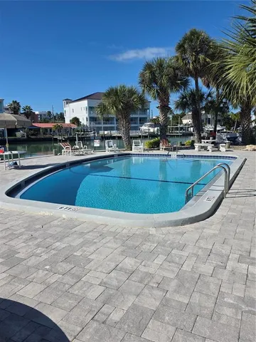 a view of outdoor space with swimming pool and seating