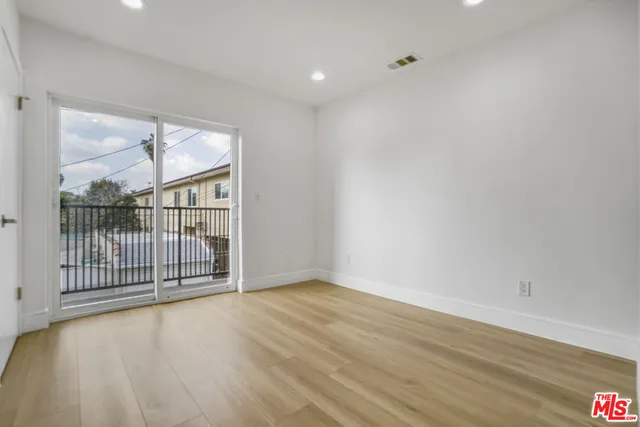 a view of a room with wooden floor and windows