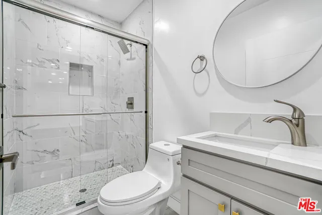 a bathroom with a sink toilet and shower