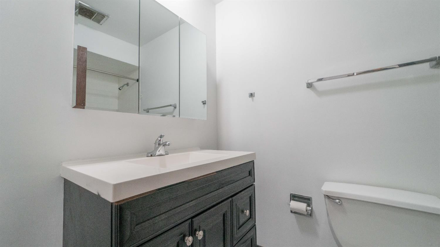 1925 Martha Street Munster, IN 46321 - Photo 19 of 23 a bathroom with a sink mirror vanity and toilet