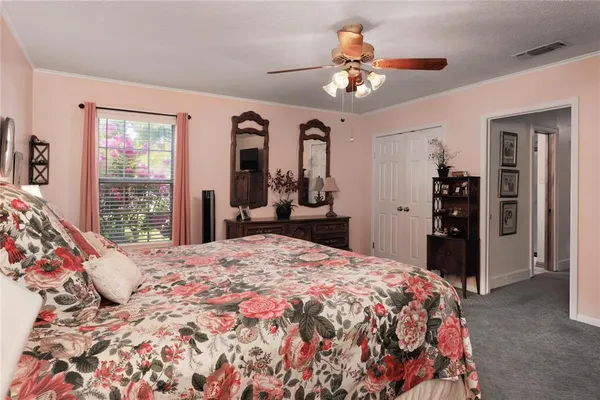 a bedroom with a large bed and a chandelier