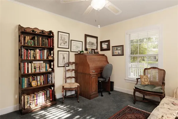 a living room with furniture and a book shelf