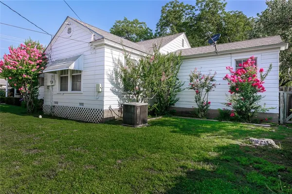 a view of a house with a yard and a garden