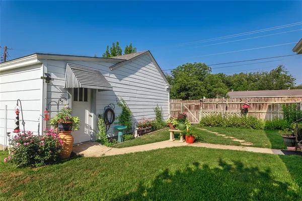 a view of a house with backyard and sitting area