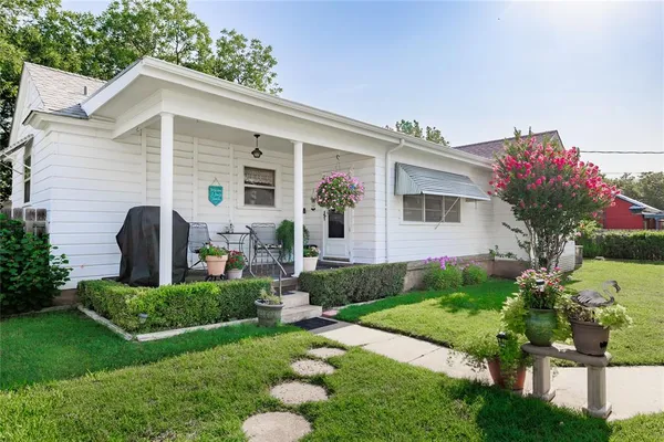 a front view of house with yard and green space