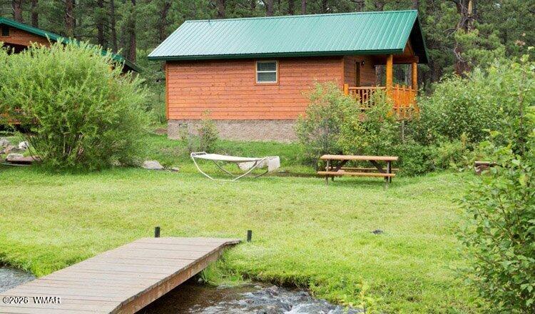 97 Rohrer Road Greer, AZ 85927 - Photo 3 of 14 a backyard of a house with table and chairs