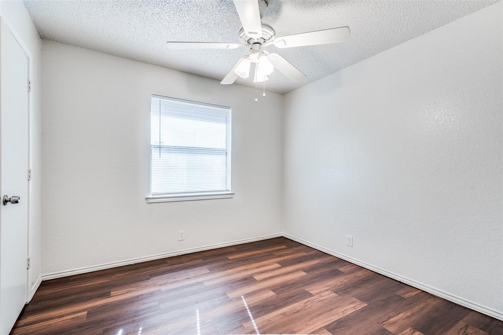 2820 Ridgecrest Drive Fort Worth, TX 76133 - Photo 17 of 25 Spare room featuring ceiling fan, baseboards, wood finished floors, and a textured ceiling