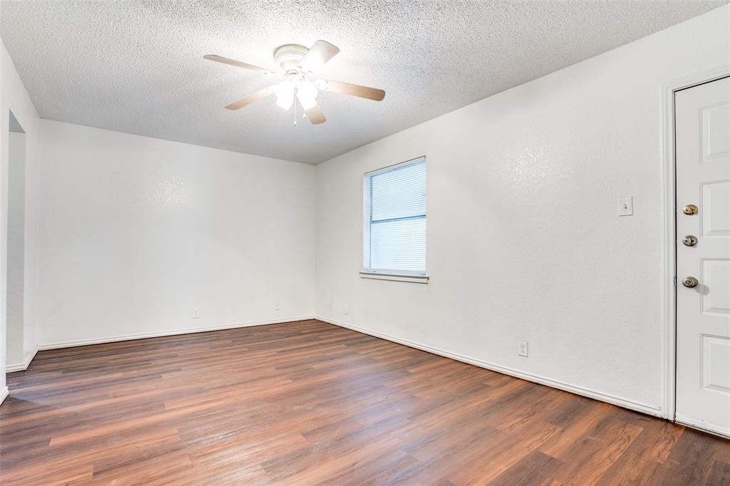 2820 Ridgecrest Drive Fort Worth, TX 76133 - Photo 18 of 25 Unfurnished room with wood finished floors, a textured ceiling, baseboards, and ceiling fan