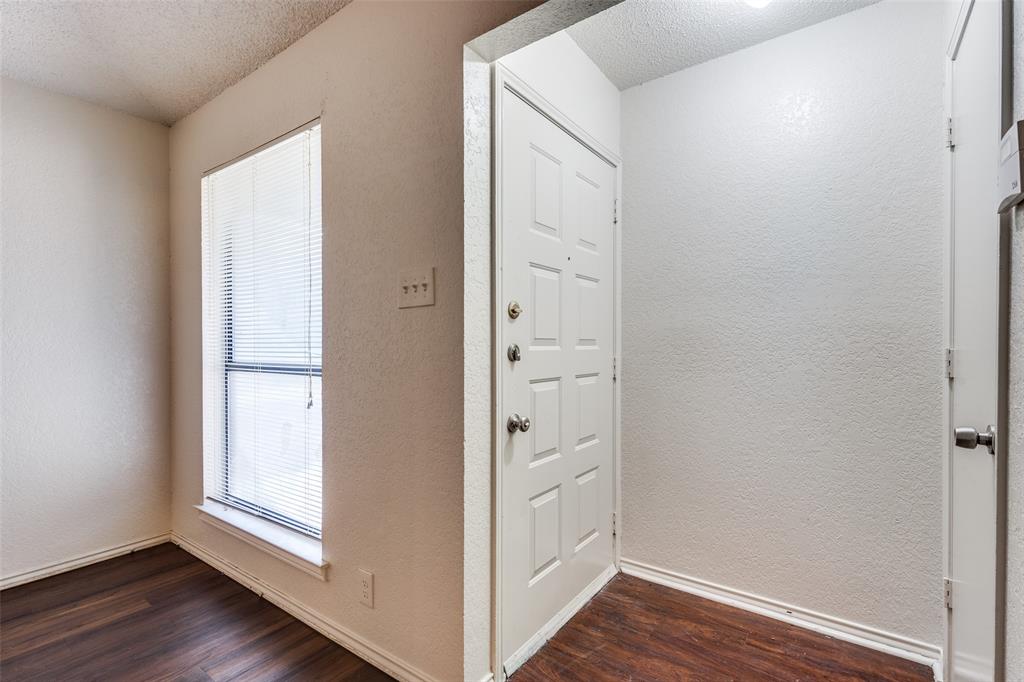 2820 Ridgecrest Drive Fort Worth, TX 76133 - Photo 5 of 25 Entrance foyer with dark wood finished floors, a textured wall, a textured ceiling, and baseboards