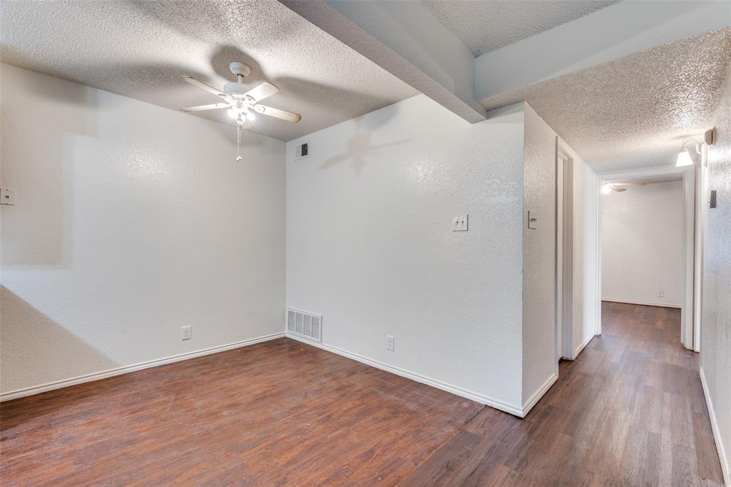 2820 Ridgecrest Drive Fort Worth, TX 76133 - Photo 10 of 25 Unfurnished room with a ceiling fan, visible vents, and a textured ceiling