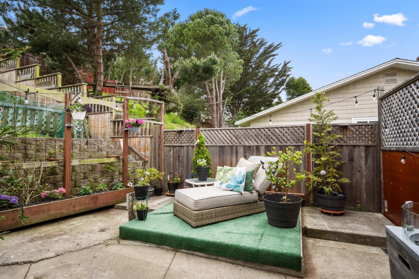 970 Park Pacifica Avenue Pacifica, CA 94044 - Photo 29 of 61 a view of a patio with couches table and chairs and potted plants