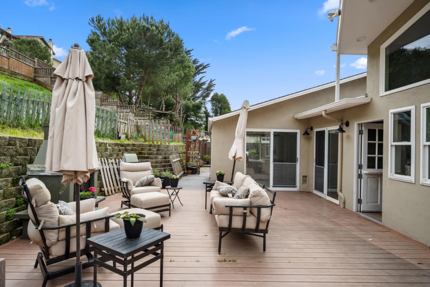 970 Park Pacifica Avenue Pacifica, CA 94044 - Photo 48 of 61 a view of a patio with a dining table and chairs with wooden floor
