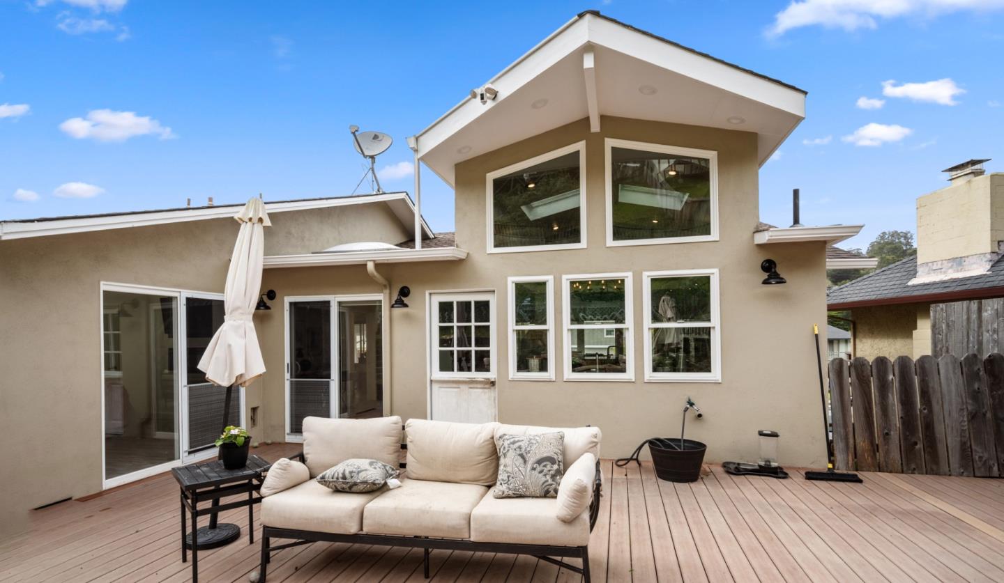 970 Park Pacifica Avenue Pacifica, CA 94044 - Photo 50 of 61 a view of a patio with couches table and chairs and potted plants