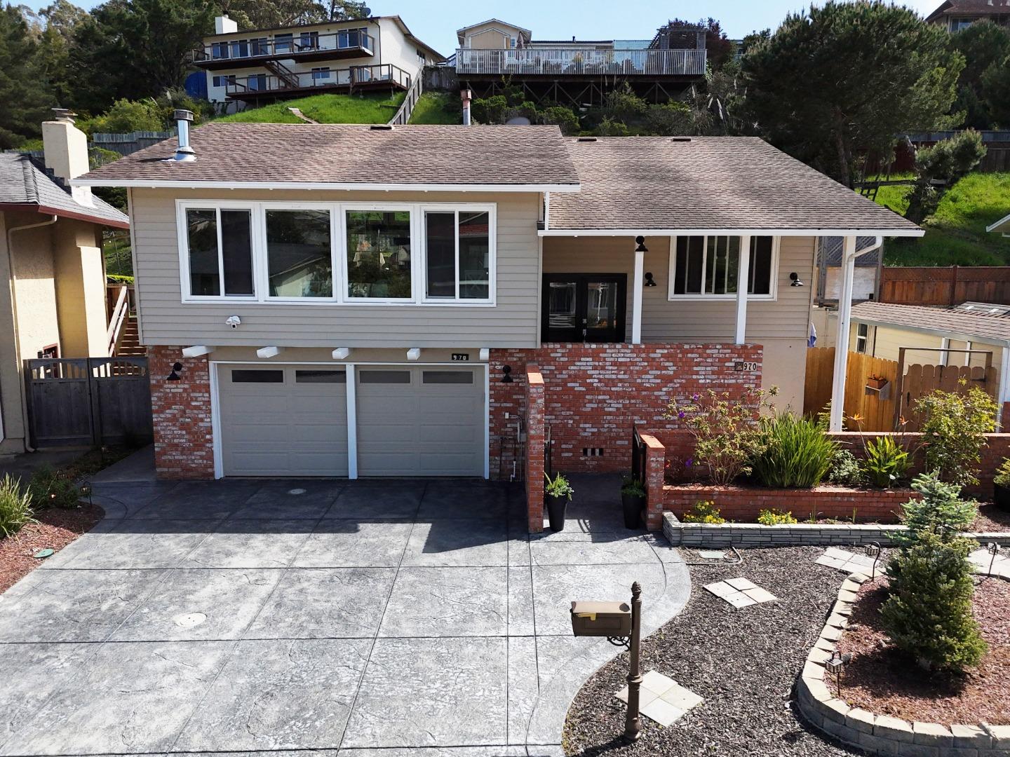 970 Park Pacifica Avenue Pacifica, CA 94044 - Photo 53 of 61 a view of a white house with a yard and sitting area