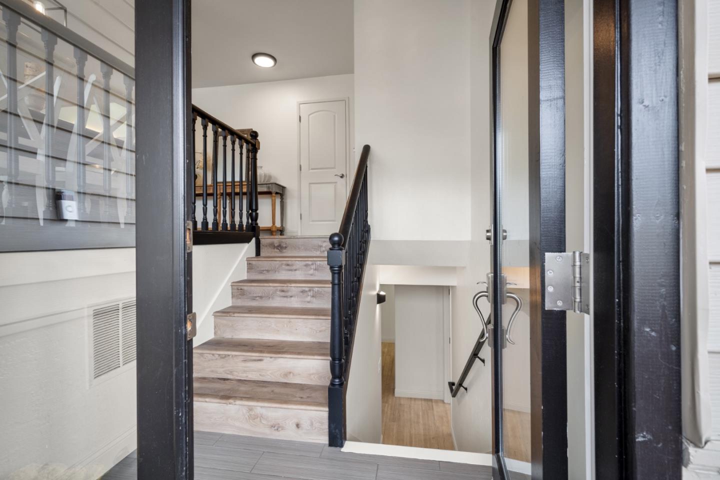 970 Park Pacifica Avenue Pacifica, CA 94044 - Photo 5 of 61 a view of staircase with white walls and a window