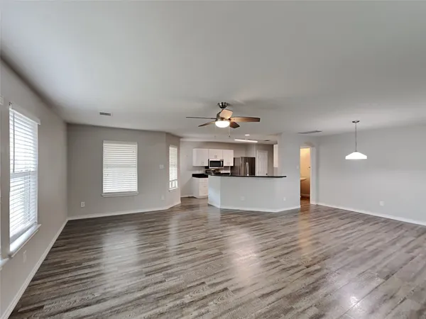 a view of a kitchen with wooden floor and a sink