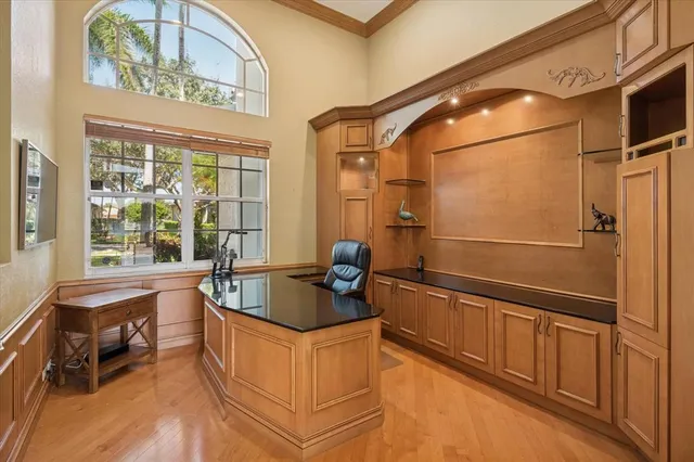 a kitchen with granite countertop a sink and a refrigerator