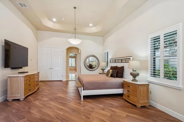 a bedroom with furniture and a flat screen tv