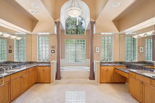 a large spacious bathroom with a large tub and large windows