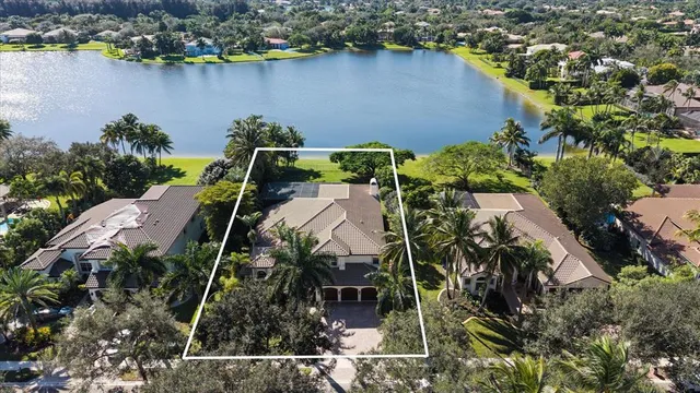 an aerial view of a house with a lake view
