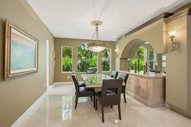 a dining room with furniture a chandelier and wooden floor