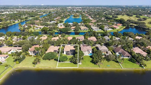 an aerial view of residential houses with outdoor space and swimming pool