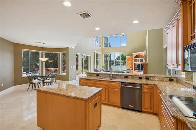 a kitchen with stainless steel appliances granite countertop a sink and stove
