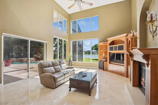 a living room with furniture and a fireplace with a large window