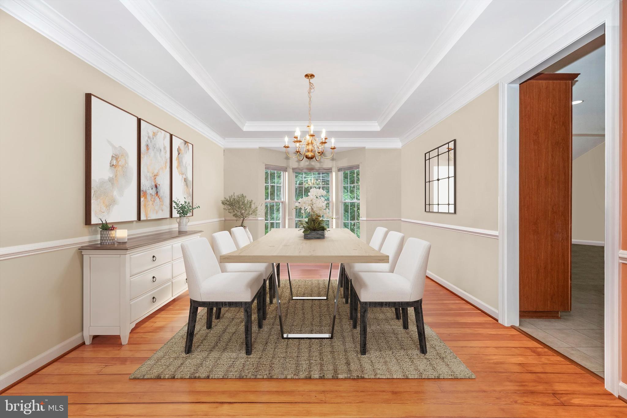 6636 South Clifton Road Frederick, MD 21703 - Photo 10 of 81 a dining room with wooden floor a chandelier a wooden table and chairs
