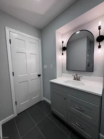 a view of a hallway with wooden floor and closet
