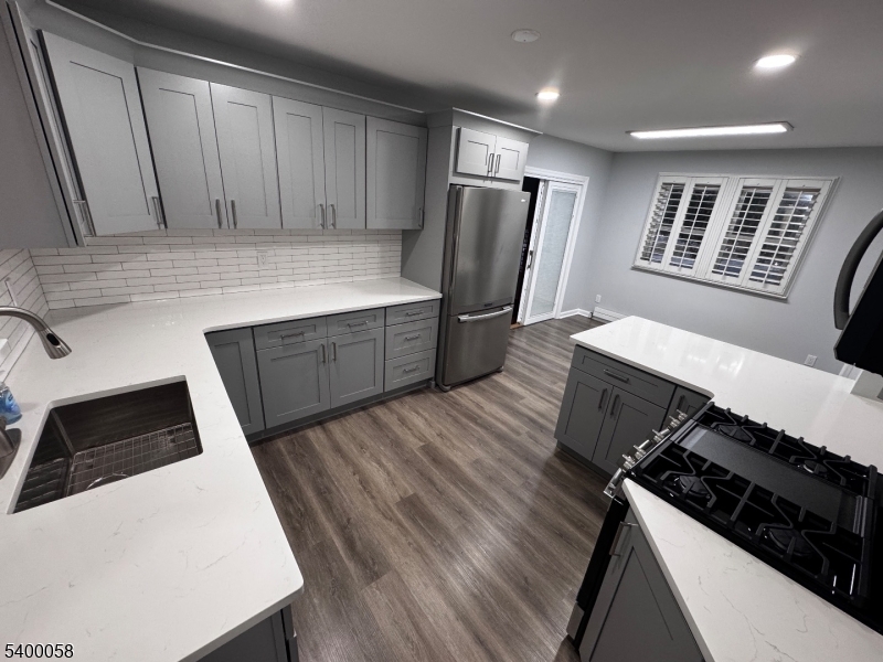 3 Fulper Place Clinton, NJ 08809 - Photo 3 of 49 a kitchen with a refrigerator and a stove top oven