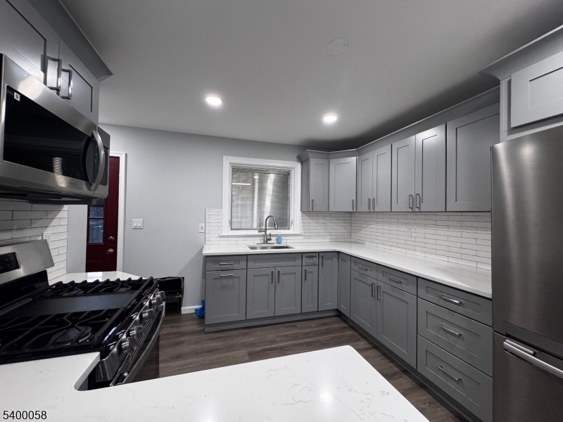 3 Fulper Place Clinton, NJ 08809 - Photo 4 of 49 a kitchen with stainless steel appliances granite countertop a sink and stove top oven with wooden floor