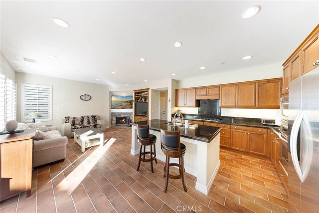 a kitchen with a table chairs refrigerator and cabinets