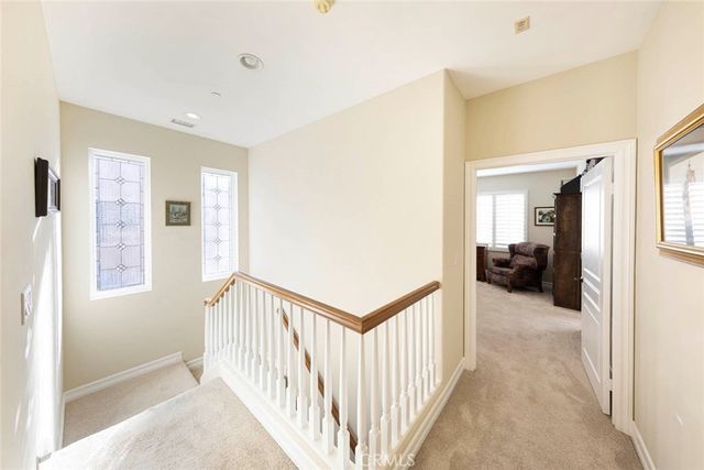 a view of a hallway with a livingroom and a windows