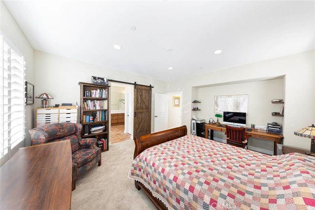 a bedroom with a large bed and a tv