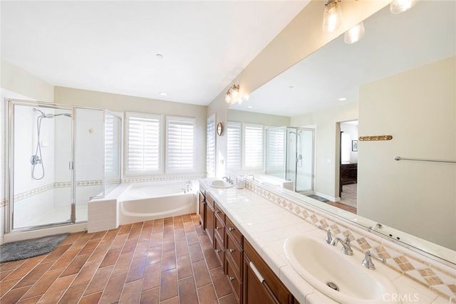 a spacious bathroom with double vanity and a bathtub