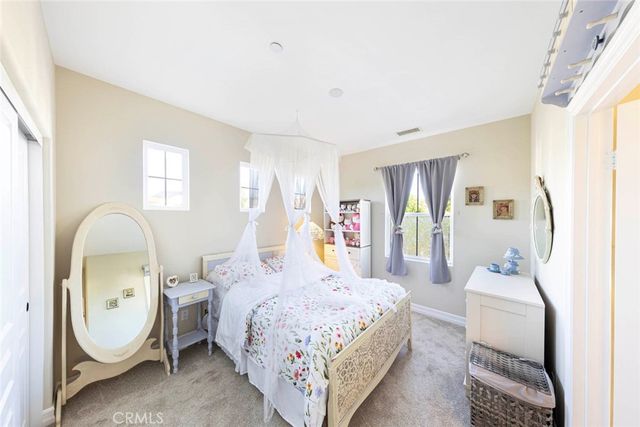 a bed room with a bed chair and a window