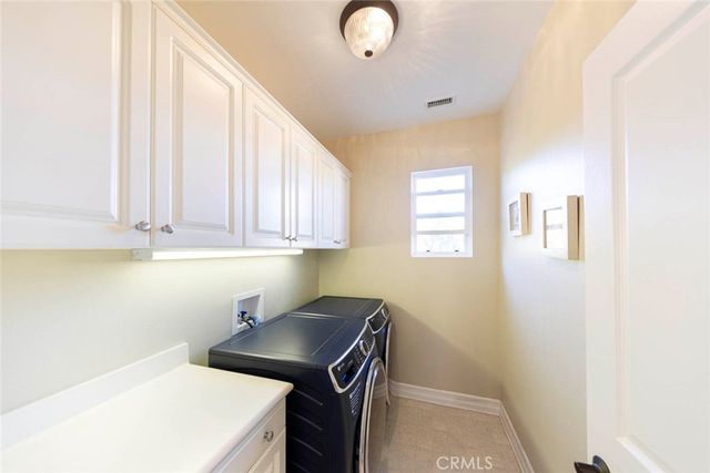 a kitchen with a sink a stove and cabinets