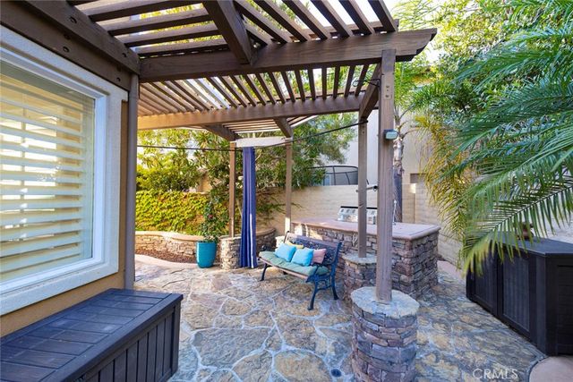 a view of a porch with furniture and a yard
