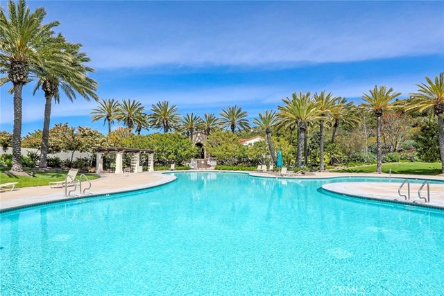 a view of a swimming pool with an outdoor space and seating area