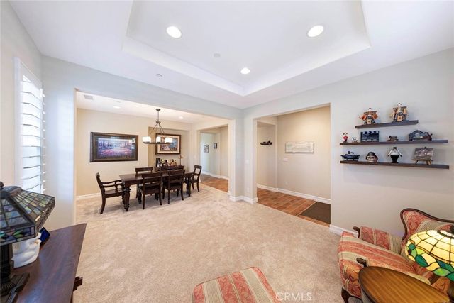 a living room with furniture and dining table